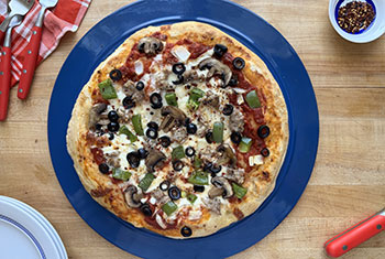 supreme style pizza with meat and veggies